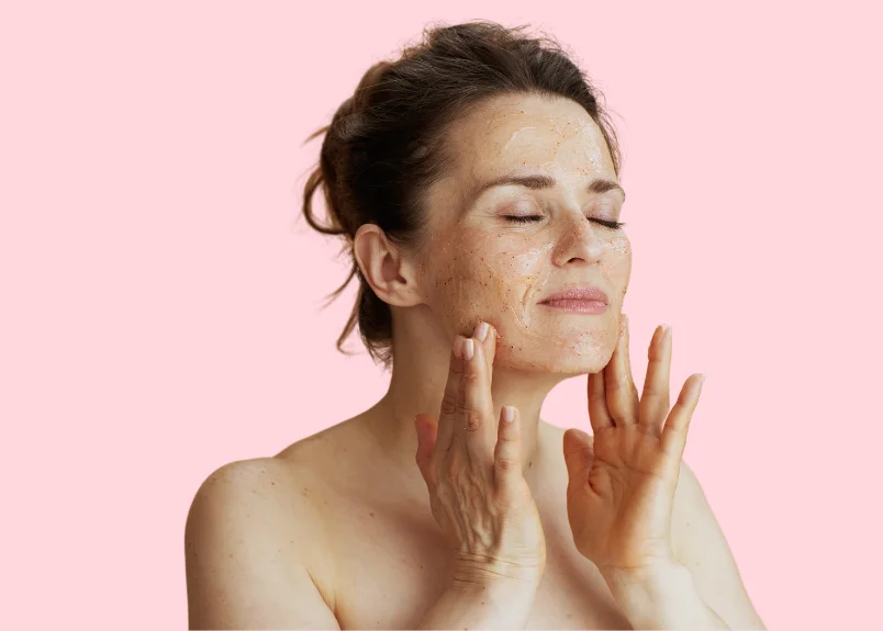 Woman exfoliating her face