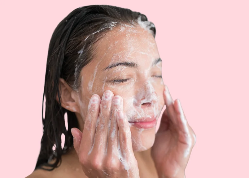 Woman doing facial cleansing post-shower