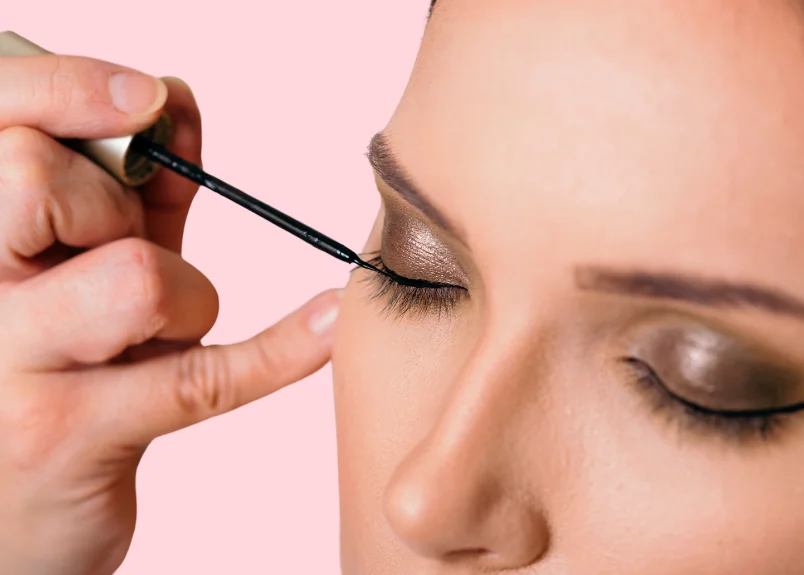 Woman applying eyeliner