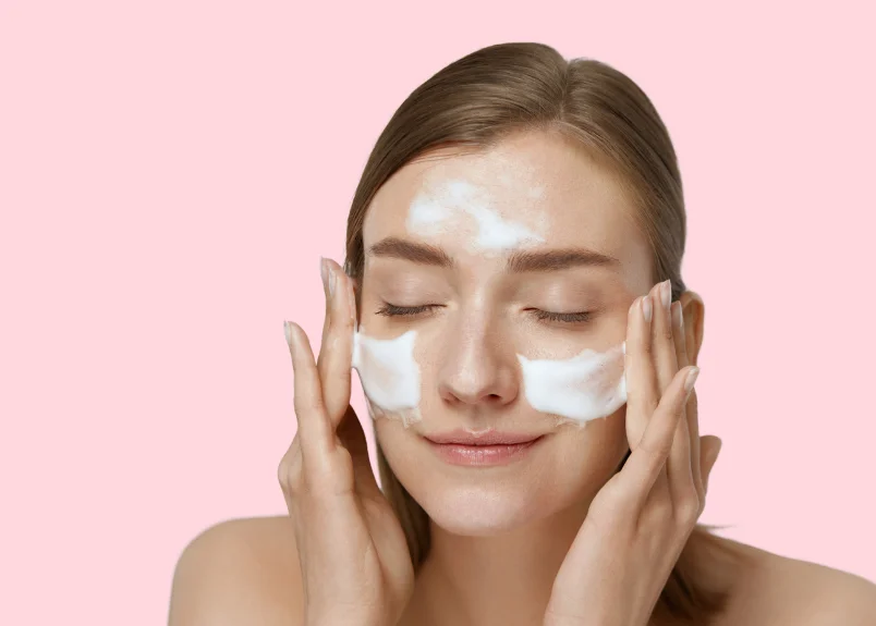 Lady with cleanser on face