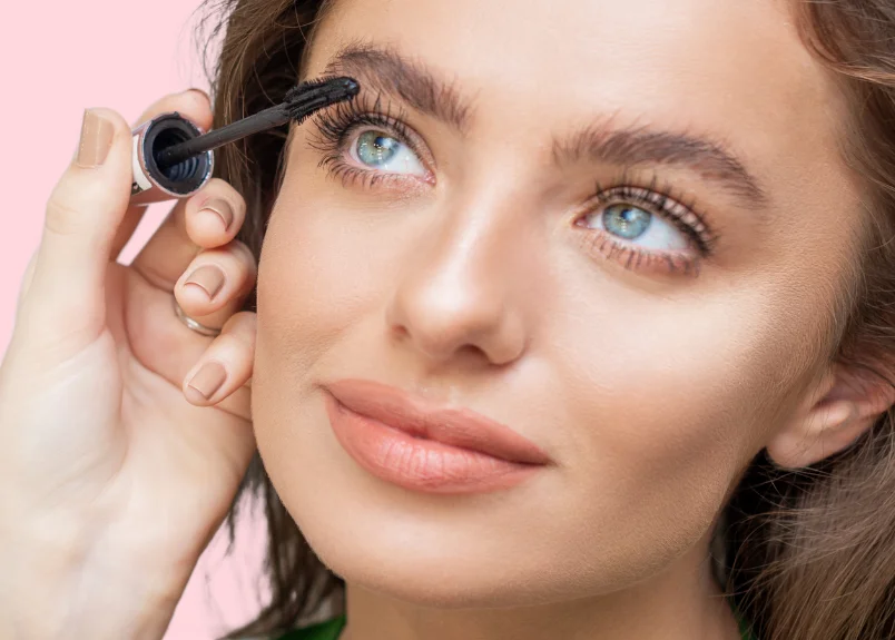 Woman applying mascara after lash lift