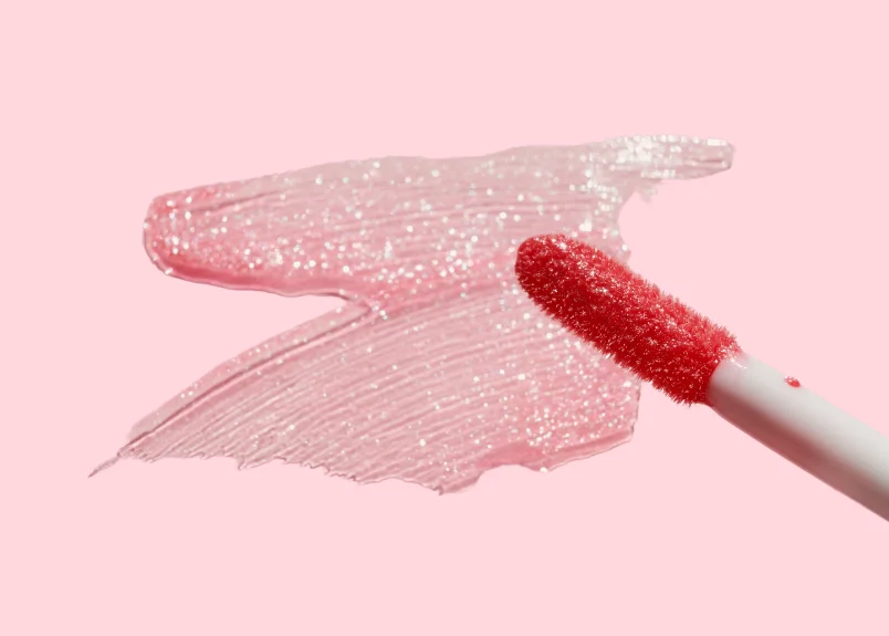 Smears of Lip gloss and lip gloss brush