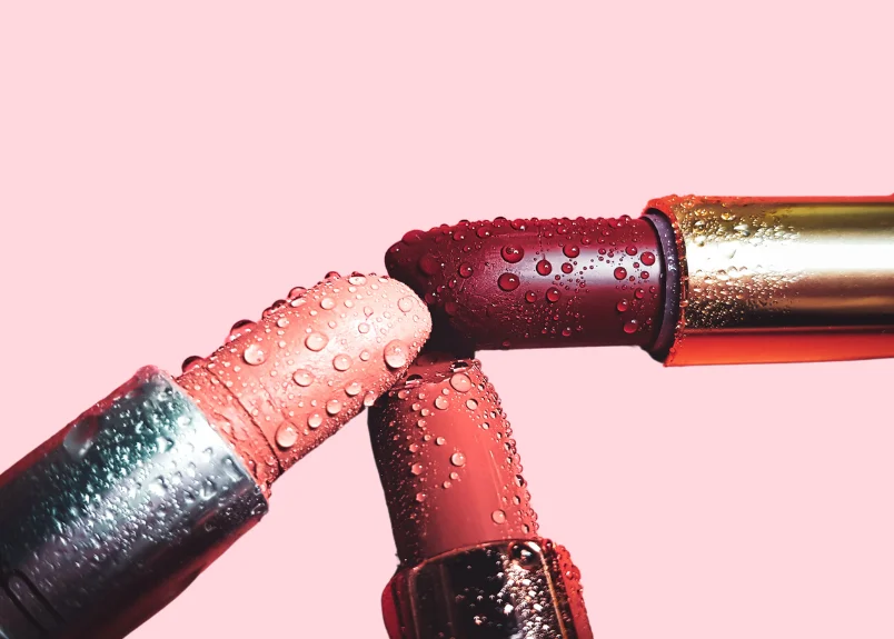 3 lipsticks with water droplets on them