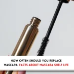 Open mascara bottle with wand ho0lded in hands and text indicating, "How often should you replace your mascara?"