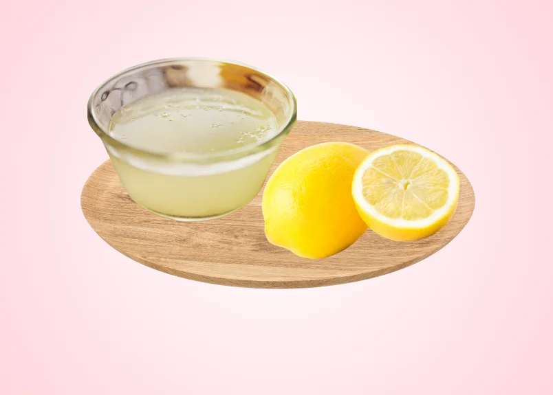 Lemon juice, lemon and lemon slice on a wooden tray