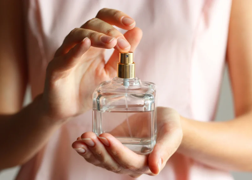 Woman holding perfume bottle