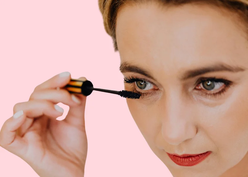Woman applying mascara