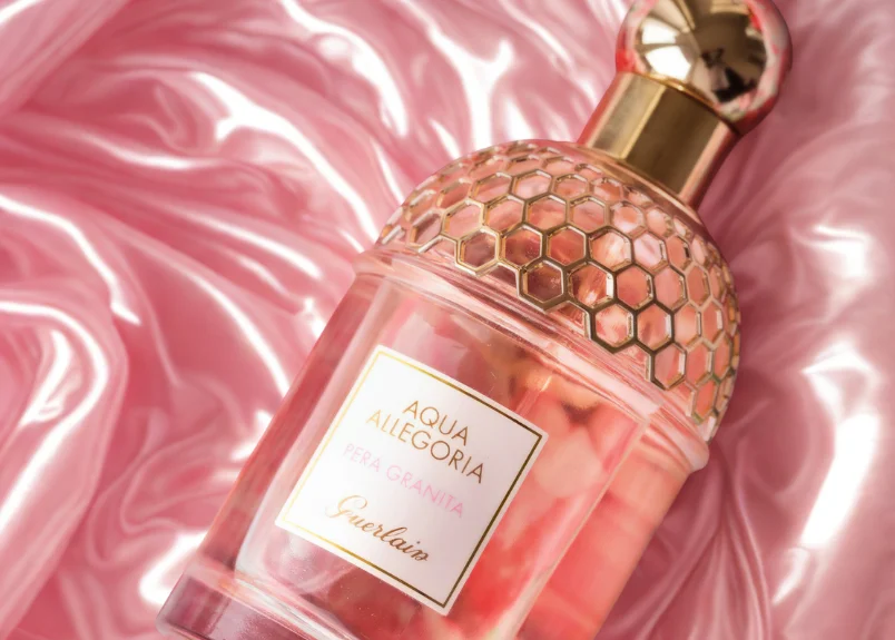 Bottle of an Arabic perfume on satin pink background