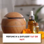 Diffuser machine and essential oil and text indicating, "Can you put perfume in a diffuser?"