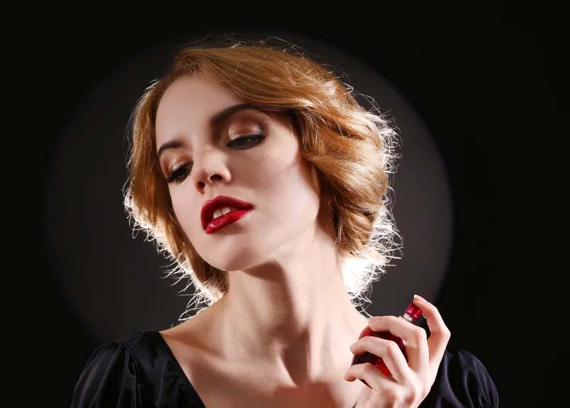 Woman applying pheromone perfume