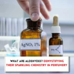 Aldehyde bottles in table, hands and txt indicating "What are aldehydes in perfume?"